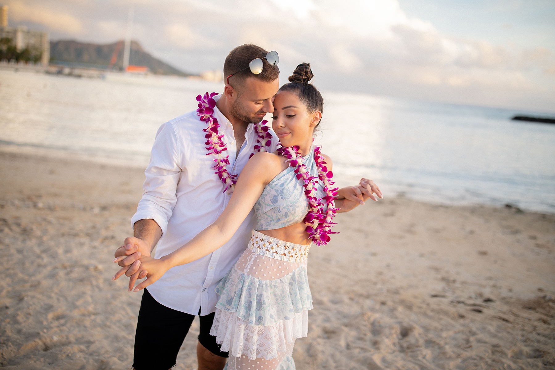 Oahu Engagement Photographer Couple Sunset Shoot Waikiki Beach Hawaiian Theme Purple Orchids Hawaii Photography